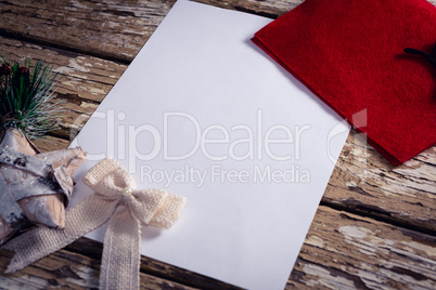 Red envelope, blank paper and christmas decorations on wooden plank