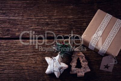 Gift boxes and christmas decoration on wooden plank