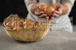 Woman holding brown eggs