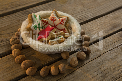 High angle view of star shape cookies in bowl amidst walnuts