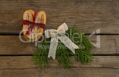 Overhead view sweet food with tied bow and pine needles on table