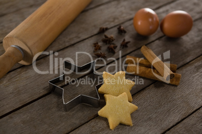 Rolling pin with eggs, cookie cutter, cookies, cinnamon and anise