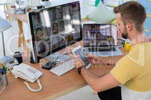 Male executive using digital tablet at desk