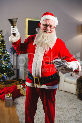Santa claus ringing a bell at home