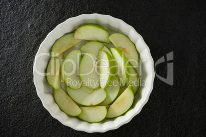 Slice of green apple on bowl