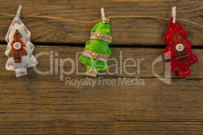 Overhead view of Christmas tree shapes attached with clip on rope