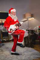 Smiling santa claus playing a guitar