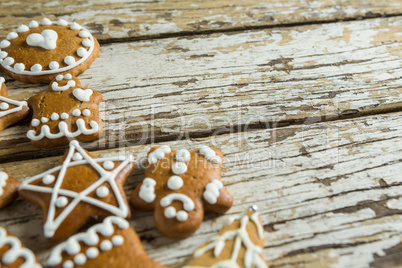 Gingerbread cookies arranged on wooden plank