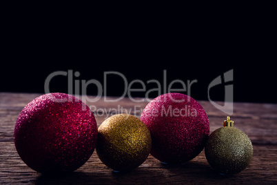 Christmas baubles on wooden plank