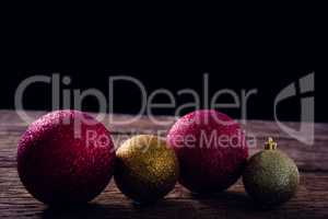 Christmas baubles on wooden plank