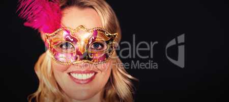 Portrait of happy woman in masquerade mask