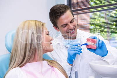 Dentist showing dental mold to patient