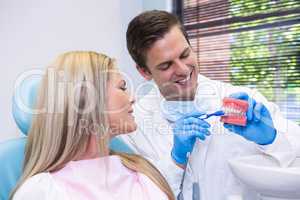 Dentist showing dental mold to patient