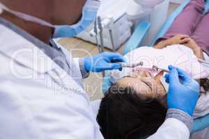 Close up of dentist examining woman mouth