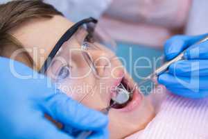 Dentist examining boy at clinic