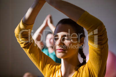 Woman meditating in prayer position at club