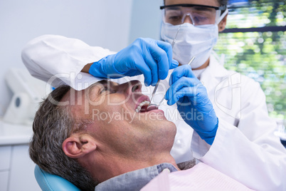 Happy man receiving dental treatment by dentist