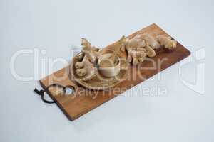 Organic gingers and powder on wooden serving board