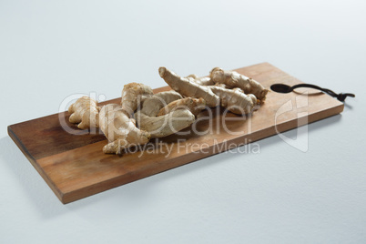 High angle view of fresh gingers on wooden serving board