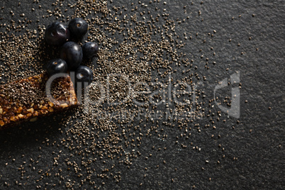 Granola bar with grains and java plum on black background