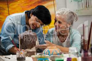 Woman painting a sculptor