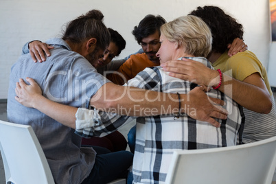 Friends huddling in art class