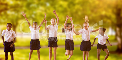 Composite image of full length of students in school uniforms jumping