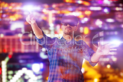 Composite image of full length of businessman looking though virtual reality simulator