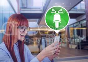 Woman holding phone with motorbike icon