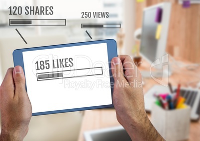 Holding tablet with Likes status bars and views and shares