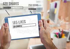 Holding tablet with Likes status bars and views and shares