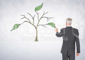 Man holding pen and Drawing of Plant branches and leaves on wall