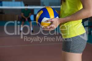Mid section side view of volleyball player holding ball