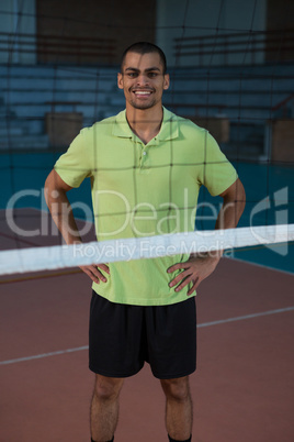 Portrait of smiling volleyball player standing at court