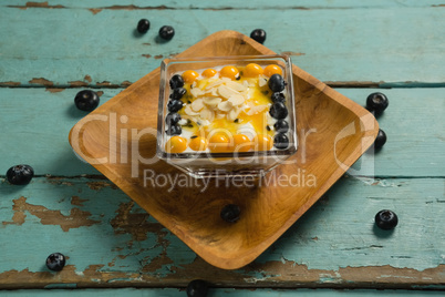 Yogurt with blueberries and golden berries in bowl