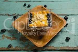 Yogurt with blueberries and golden berries in bowl