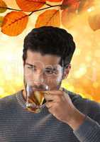 Man drinking tea with Autumn leaves background