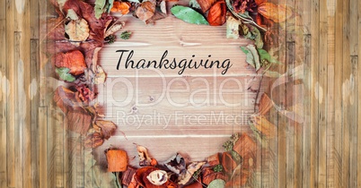 thanksgiving text with rustic Autumn leaves and wood