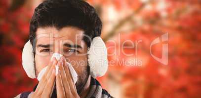 Composite image of close-up portrait of man blowing nose with tissue paper