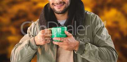Composite image of portrait of man holding mug of coffee