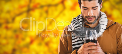 Composite image of man holding wineglass against white background