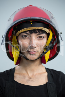 Female architect wearing helmet against white background