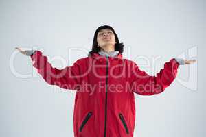 Blissful woman standing with arms outstretched