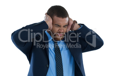 Irritated businessman covering his ears