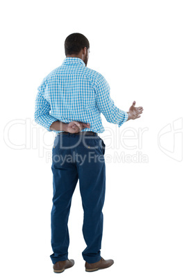 Male executive offering handshake against white background