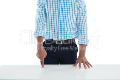 Male executive touching invisible screen on desk