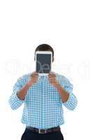 Male executive hiding his face with digital tablet