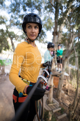 Woman enjoying zip line adventure in park