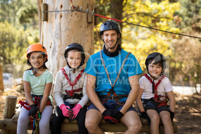 Kids and instructor sitting together in park