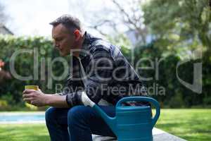 Man having cup of coffee in garden